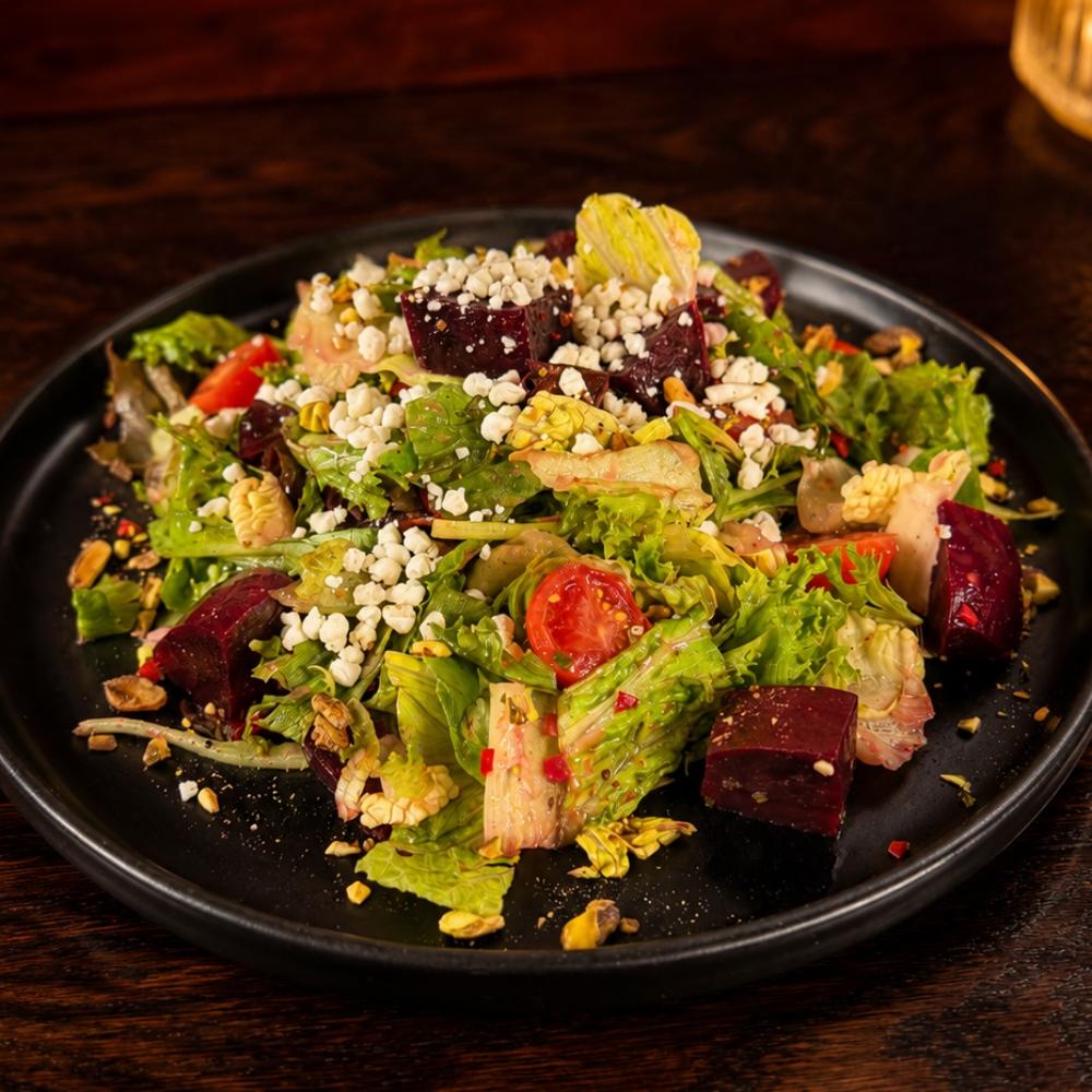 Roasted beet salad with tomatoes, pistachio and goat cheese