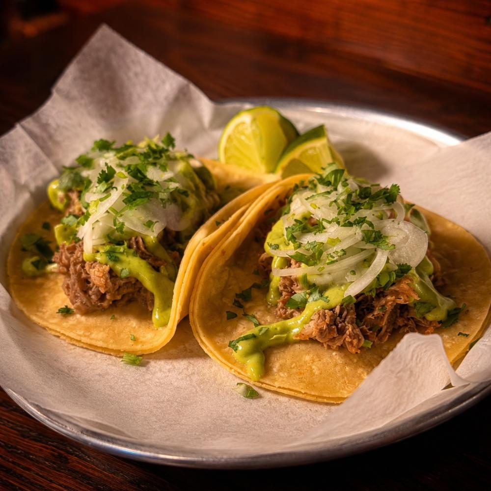Carnitas tacos with confit pork, avocado salsa, onions and cilantro