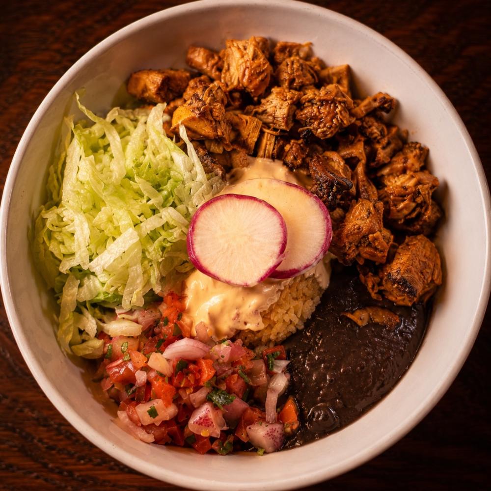 Chipotle chicken bowl with black beans, rice, pico de gallo and queso fresco