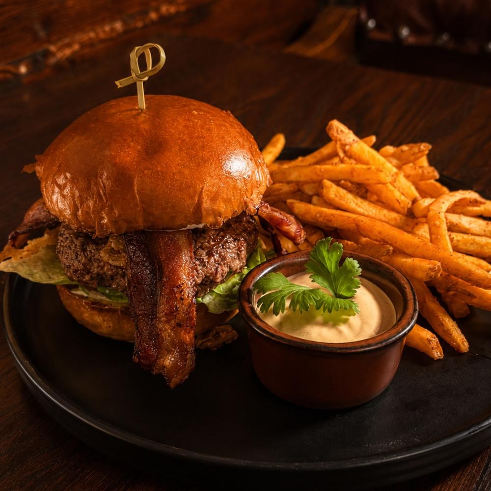 Cocina burger with bacon, cheddar, crispy onions and seasoned fries