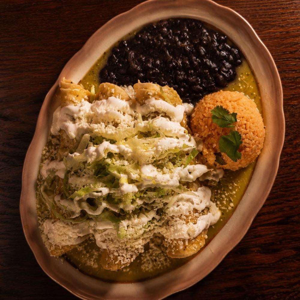 Enchiladas verde with braised chicken, rice and black beans