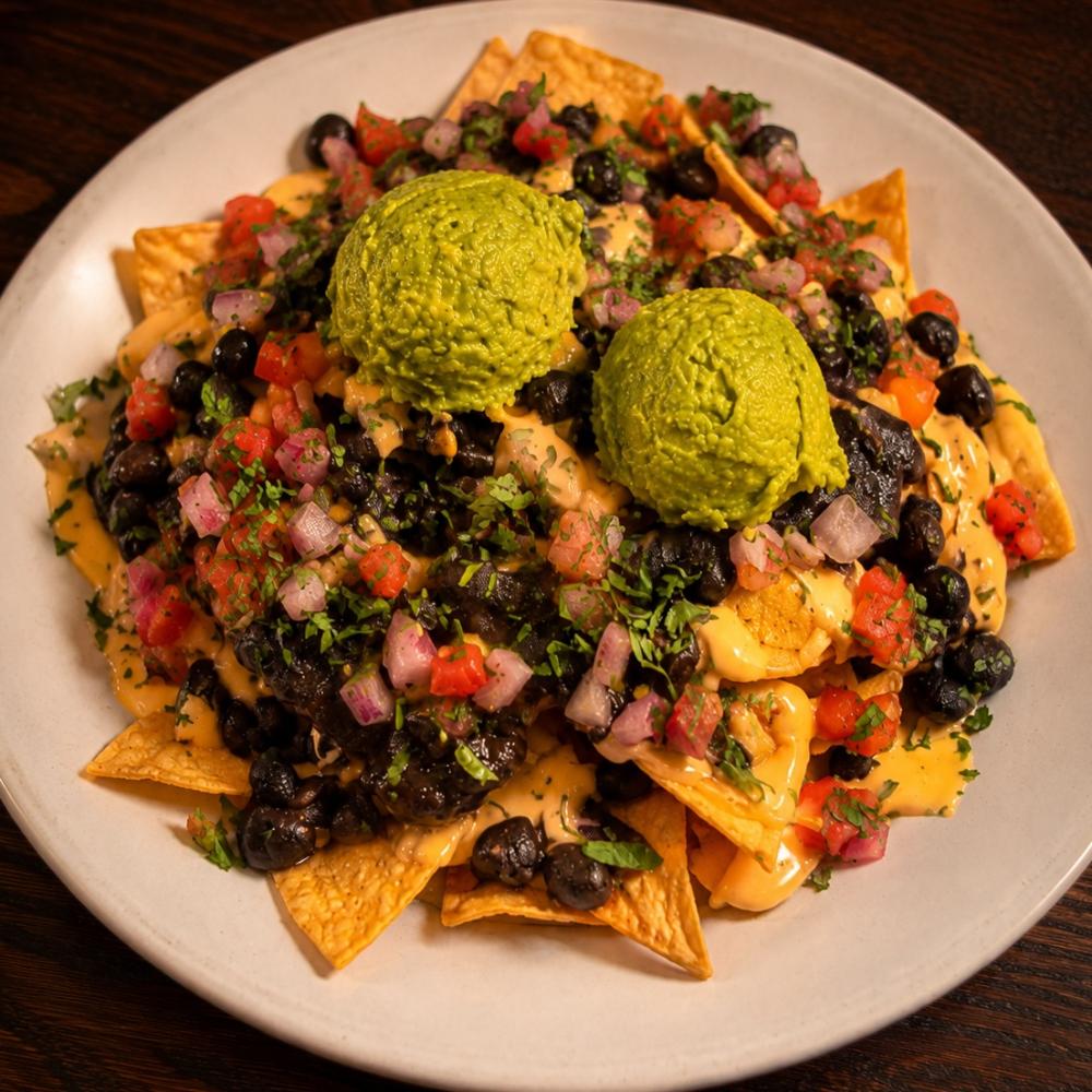 Nachos with queso, beans, pico de gallo and guacamole